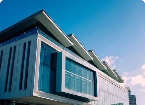 A building with many windows and some glass on the outside.