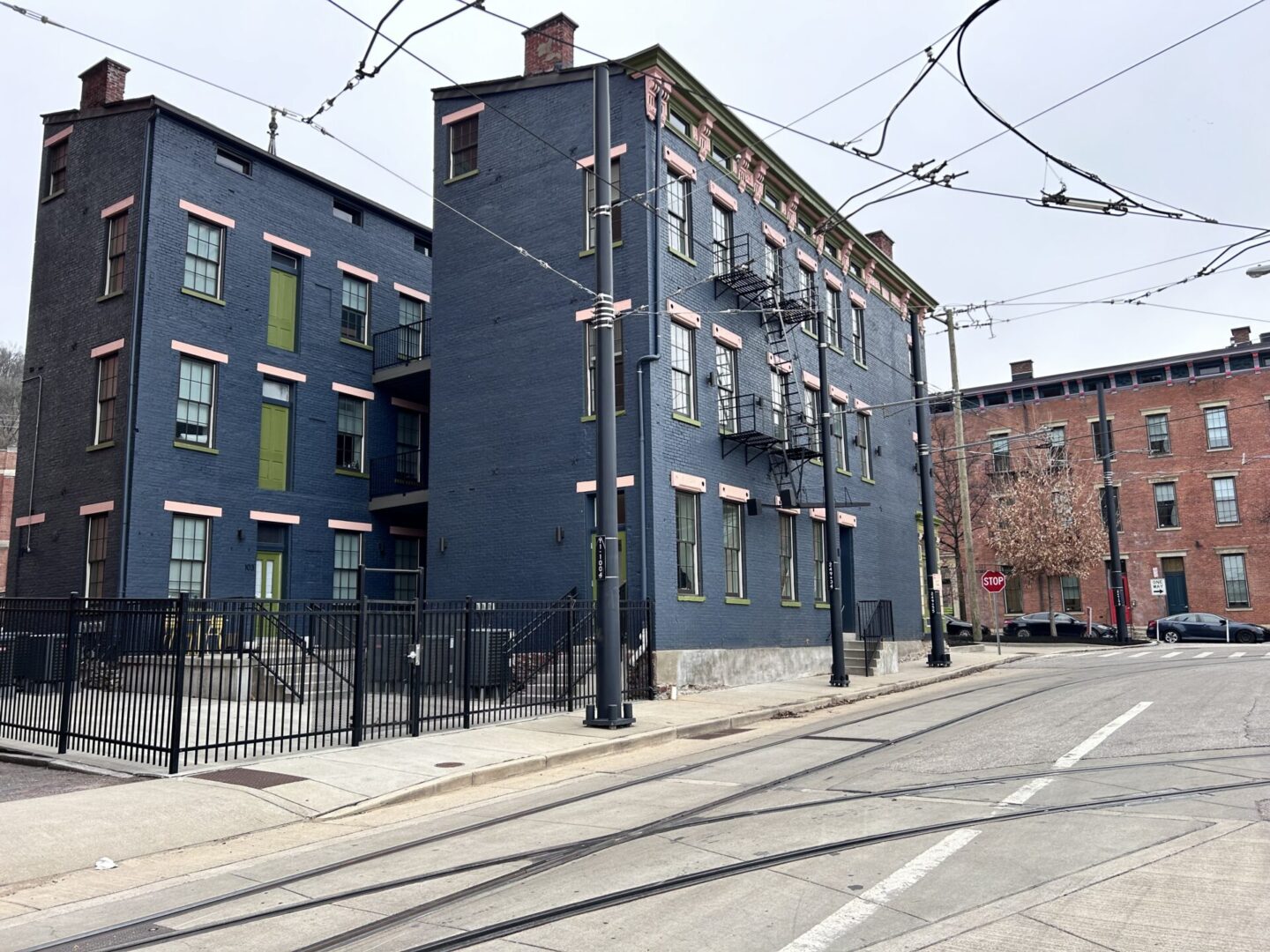 A street with buildings and wires on the side.